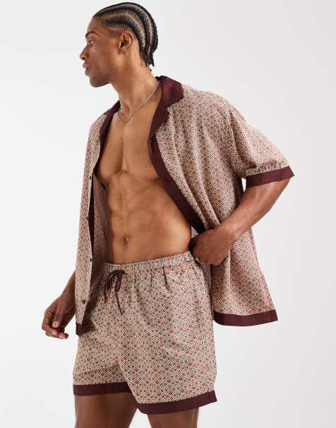 ASOS DESIGN swim shorts in short length in orange geo print with border - part of a set - view 1