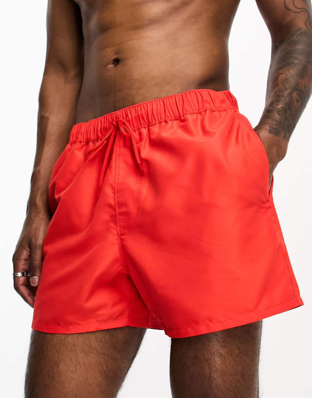 ASOS DESIGN swim shorts in short length in red