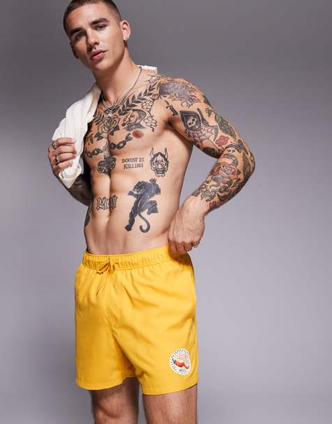 ASOS DESIGN swim shorts in short length in yellow - view 1