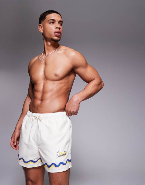ASOS DESIGN swim shorts in short length with border print in stone - view 1