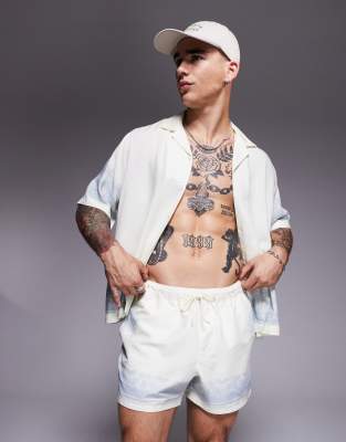 ASOS DESIGN swim shorts in short length with border print in white - part of a set