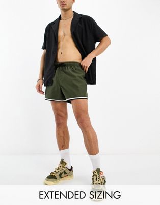 ASOS DESIGN swim shorts in short length with cargo pocket and contrast binding in khaki