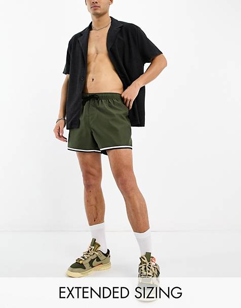 ASOS DESIGN swim shorts in short length with cargo pocket and contrast binding in khaki