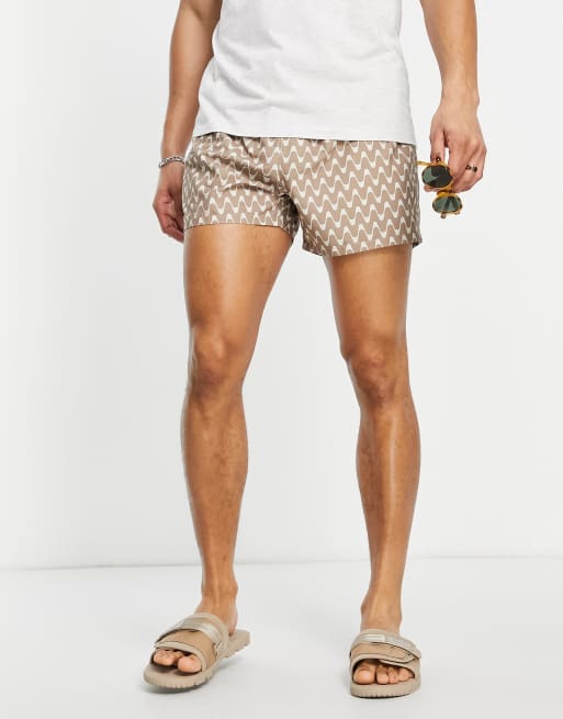 ASOS DESIGN swim shorts in short length with chevron print in beige
