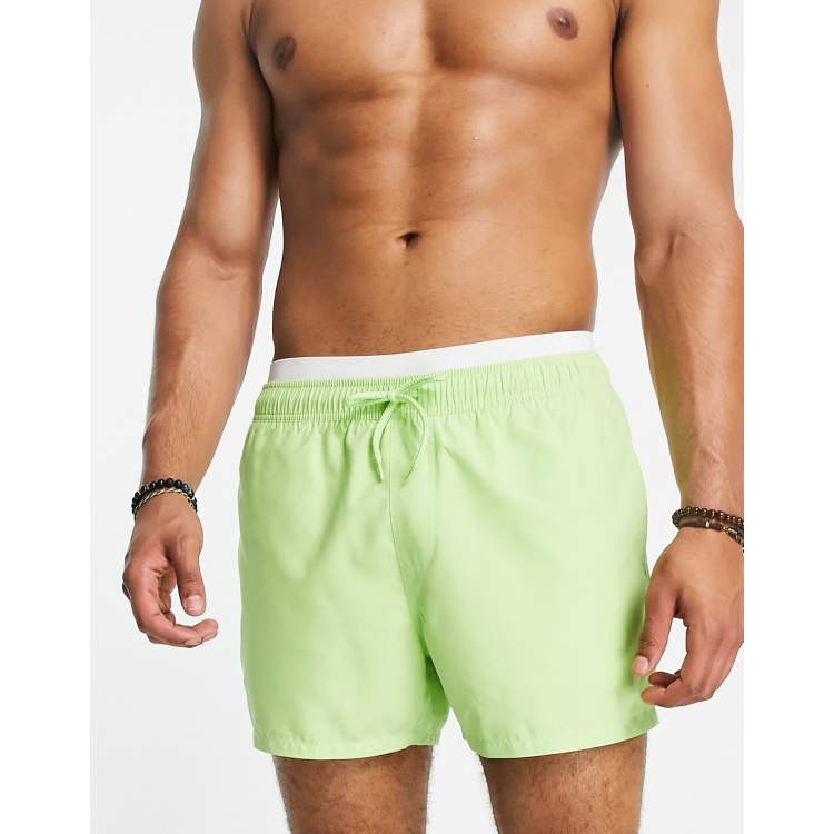 ASOS DESIGN swim shorts in short length with double waistband in lime green