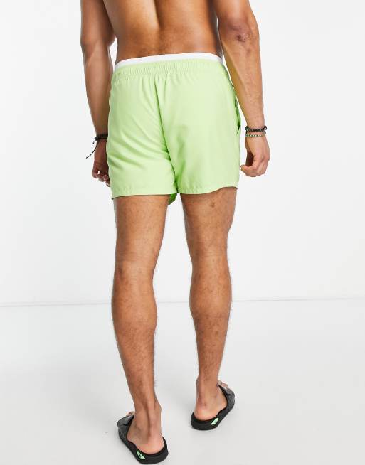 ASOS DESIGN swim shorts in short length with double waistband in lime green