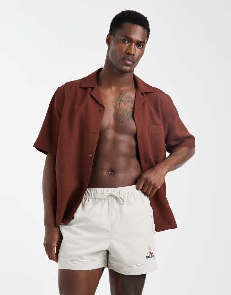 ASOS DESIGN swim shorts in short length with embroidery in beige - view 1