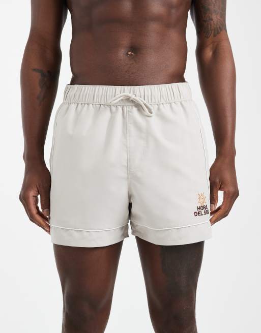 ASOS DESIGN swim shorts in short length with embroidery in beige, 6 of 6