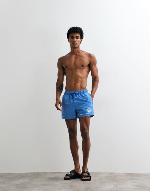 ASOS DESIGN swim shorts in short length with embroidery in blue, 2 of 5