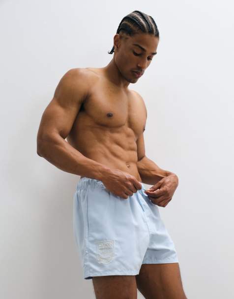 ASOS DESIGN swim shorts in short length with embroidery in blue
