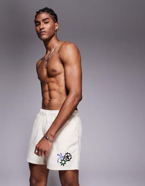 ASOS DESIGN swim shorts in short length with embroidery in neutral - view 1