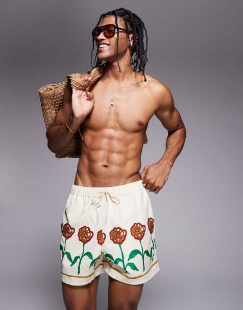 ASOS DESIGN swim shorts in short length with flower print in stone - view 1