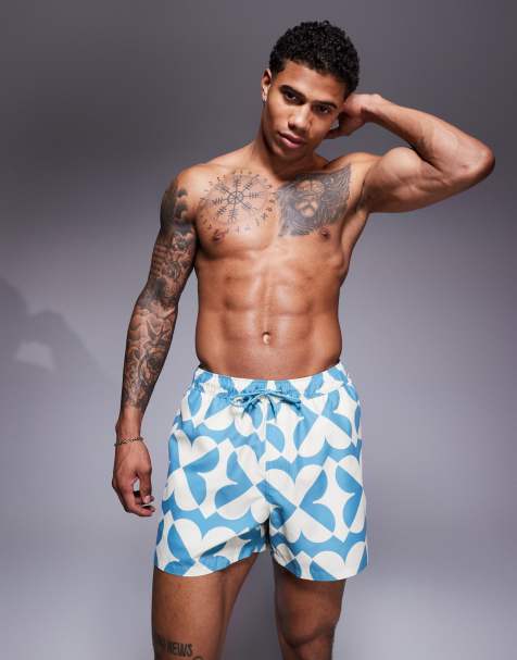 ASOS DESIGN swim shorts in short length with geo print in blue - view 1