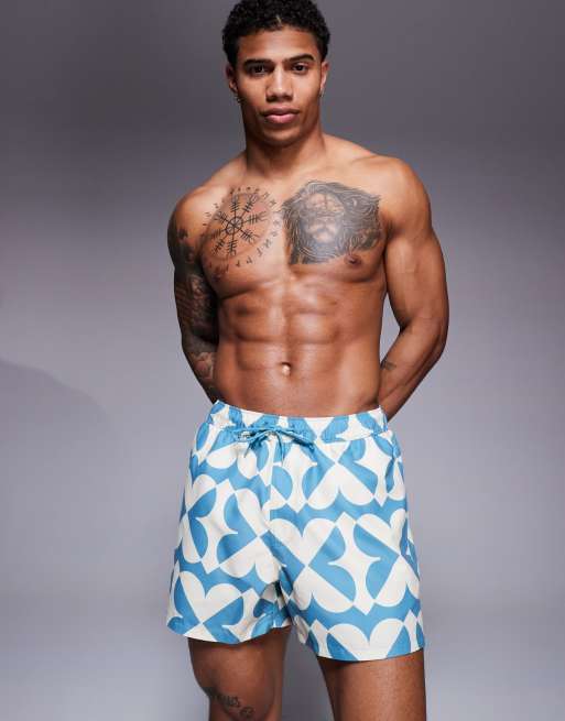 ASOS DESIGN swim shorts in short length with geo print in blue