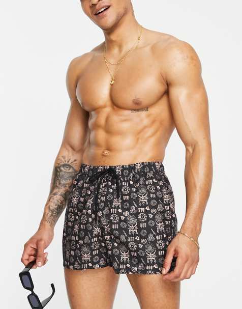 ASOS DESIGN swim shorts in short length with hand drawn design in black - view 1