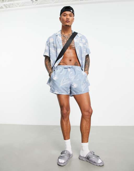 ASOS DESIGN swim shorts in short length with hand drawn floral print in blue (part of a set)