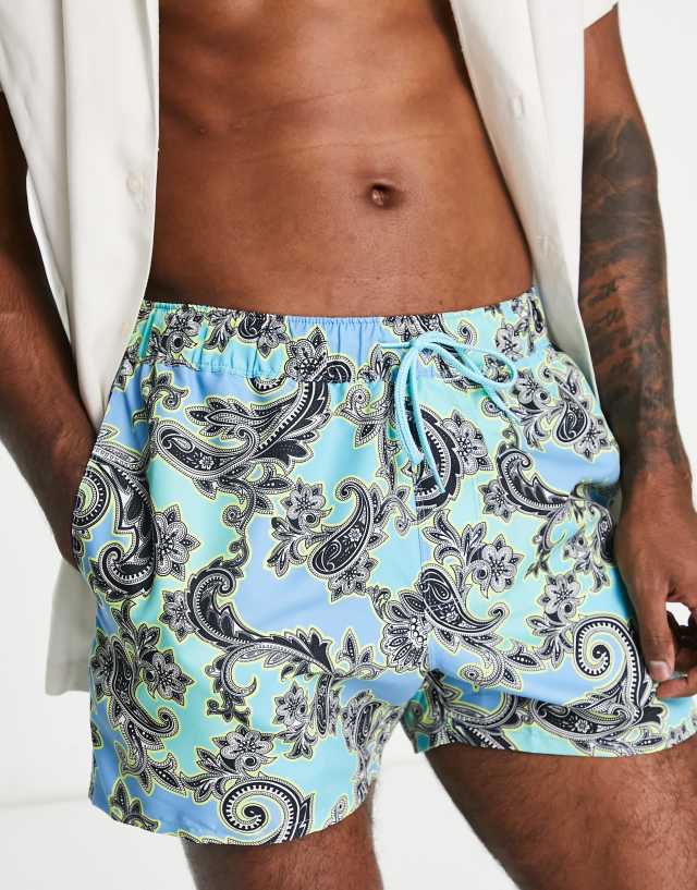 ASOS DESIGN swim shorts in short length with paisley print in blue