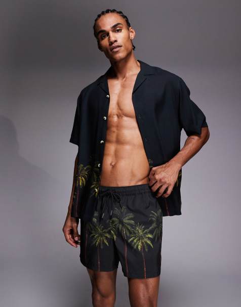 ASOS DESIGN swim shorts in short length with palm tree print in black - part of a set - view 1