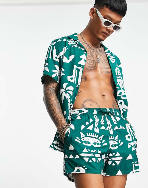 ASOS DESIGN swim shorts in short length with pattern print in dark green (part of a set)