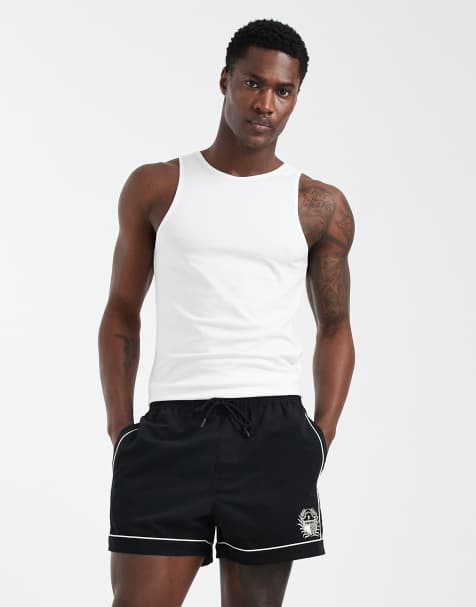 ASOS DESIGN swim shorts in short length with piping and embroidery in black - view 1