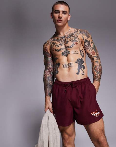 ASOS DESIGN swim shorts in short length with placement print in burgundy - view 1