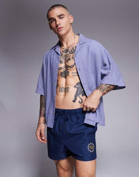 ASOS DESIGN swim shorts in short length with placement print in navy - view 1