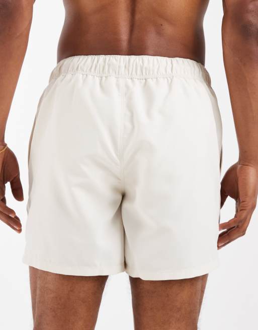 ASOS DESIGN swim shorts in short length with placement stripe in beige, 5 of 5