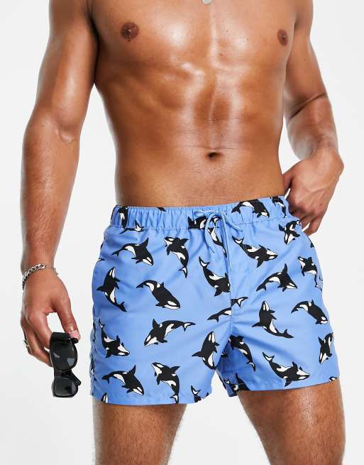 ASOS DESIGN swim shorts in short length with whale print in blue