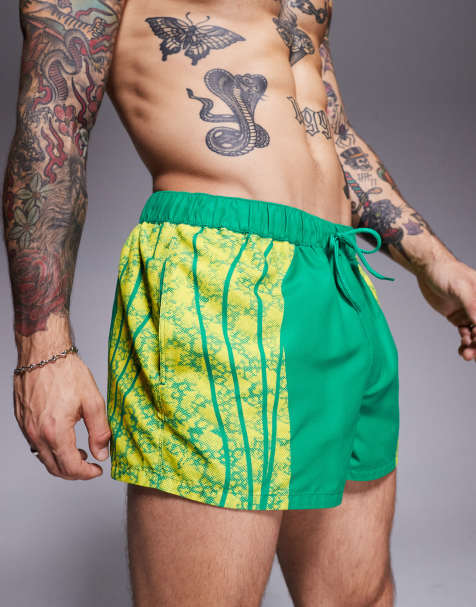 ASOS DESIGN swim shorts in super short length with placement animal print in green - view 1