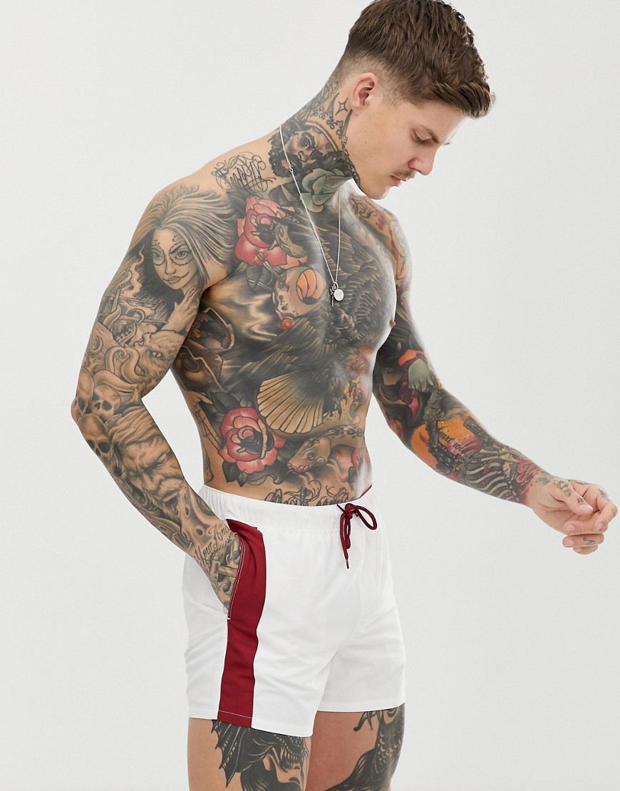 ASOS DESIGN swim shorts in white with contrast burgundy side stripe in short length-Red