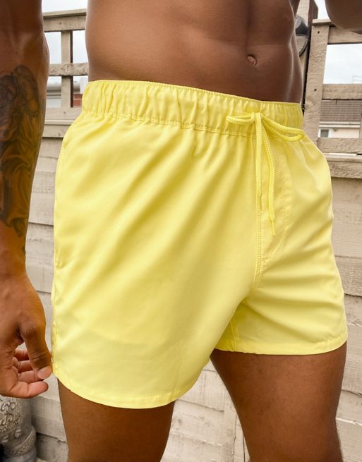 ASOS DESIGN swim shorts in short length with thick waistband in yellow