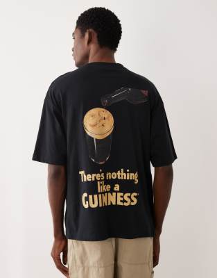 T-Shirt in Schwarz mit „Guinness"-Print in Oversize-Passform Schwarz XS