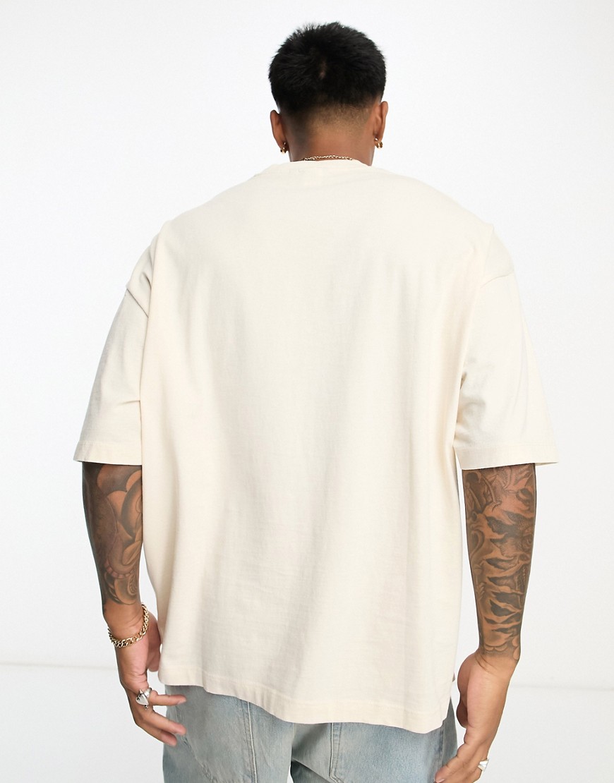 T-shirt unisex oversize in cotone non candeggiato con grafica stampata sul davanti-Bianco - ASOS DESIGN T-shirt donna  - immagine1