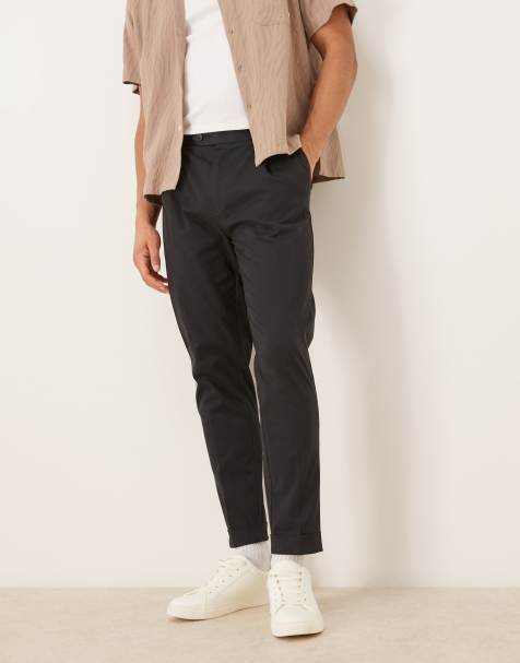 ASOS DESIGN tailored cotton rich tapered chino trousers in black with turnup - view 1