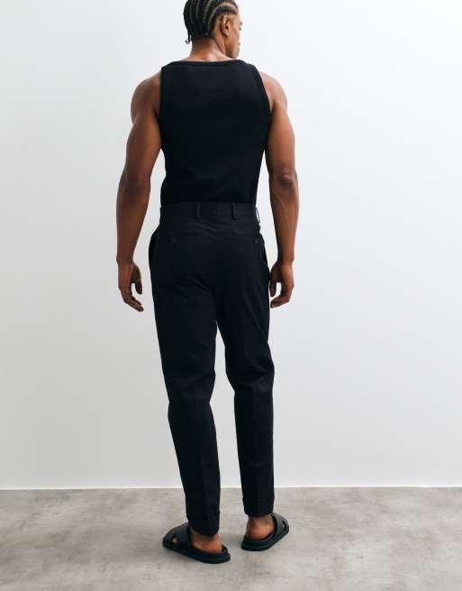 ASOS DESIGN tailored cotton rich tapered chino trousers in black with turnup, 4 of 5