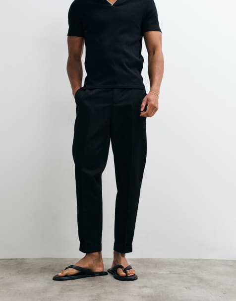 ASOS DESIGN tailored tapered pants in black with elastic waist and rolled cuffs - view 1