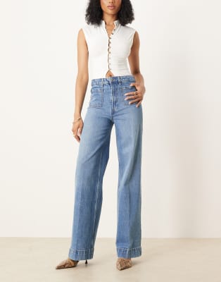 ASOS DESIGN Tall clean wide leg jeans with front pockets in mid blue