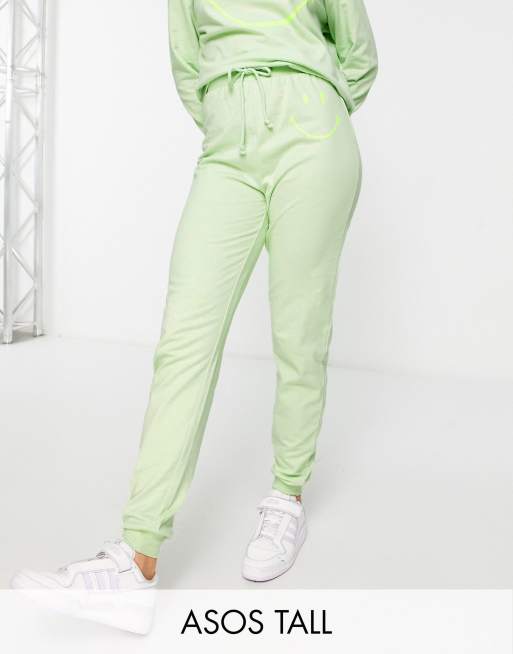 ASOS DESIGN Tall lounge Smiley trackies in lime (part of a set)