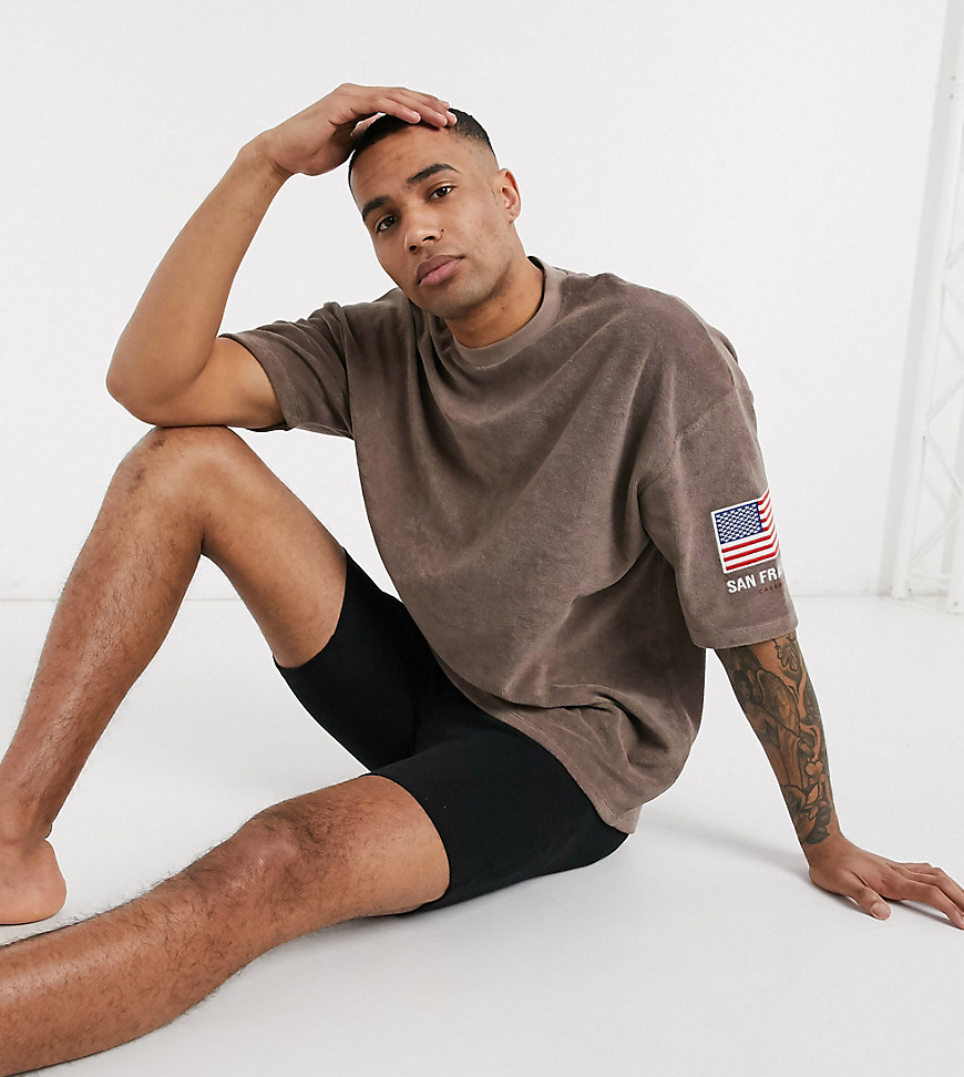 ASOS DESIGN Tall oversized longline t-shirt with flag sleeve embroidery and city print in towelling-Brown