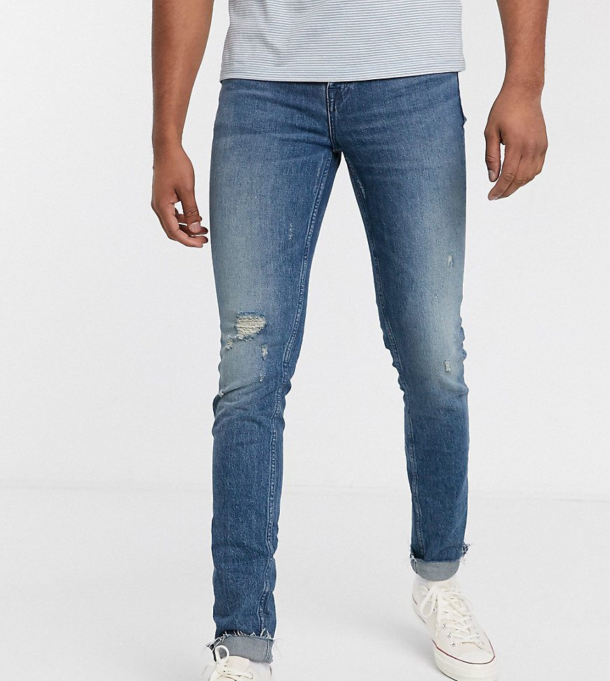 ASOS DESIGN Tall - Skinny 'American classic' jeans in blauwe midwash met slijtage en onafgewerkte zoom
