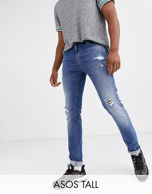 ASOS DESIGN Tall skinny jeans in mid wash blue with rips and destroy