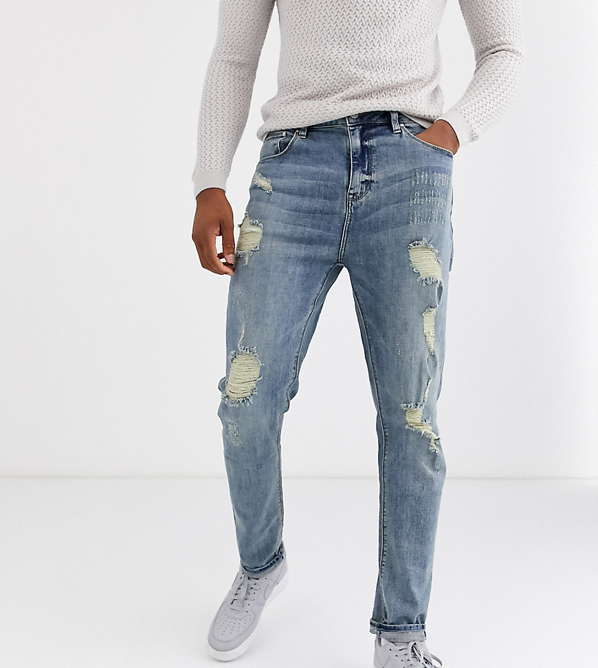 ASOS DESIGN Tall tapered jeans in light wash blue with heavy rips