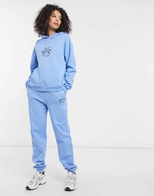 ASOS DESIGN Tall tracksuit oversized hoodie / oversized jogger with ski  motif in blue