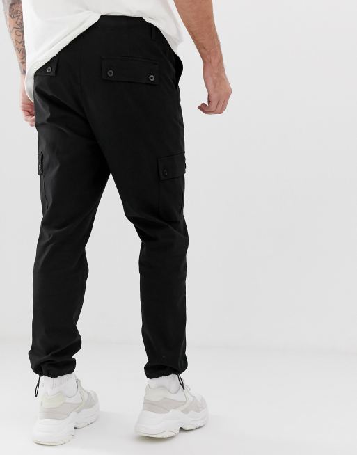 https://images.asos-media.com/products/asos-design-tapered-cargo-pants-in-black-with-toggles/11426759-2?$n_640w$&wid=513&fit=constrain