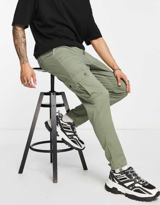 ASOS DESIGN tapered cargo pants in khaki with toggles in mist green