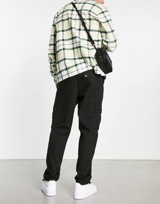 ASOS DESIGN cargo tapered pants in black with toggles