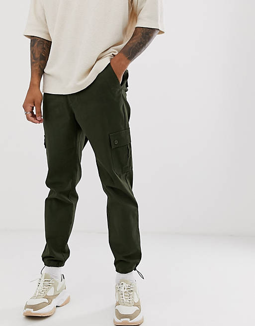 ASOS DESIGN tapered cargo pants with toggles in green | ASOS