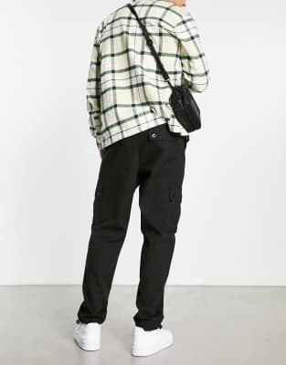 ASOS DESIGN cargo tapered pants in black with toggles
