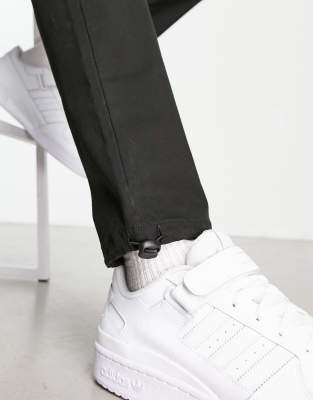 ASOS DESIGN cargo tapered pants in black with toggles