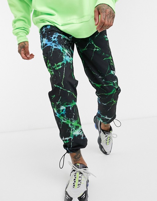 ASOS DESIGN tapered cargo joggers with toggles with abstract print